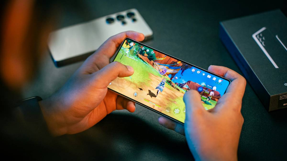 Man analyzing online gaming for adults data dashboard on smartphone